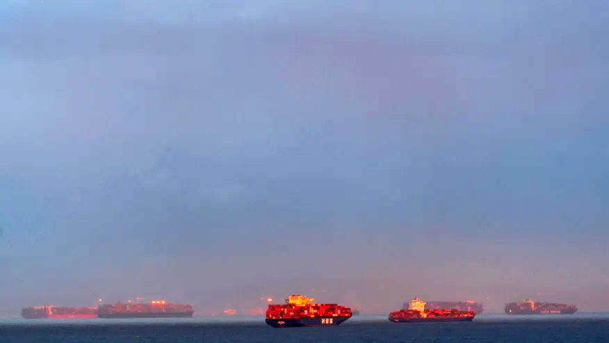 In this Wednesday, March 3, 2021 photo, a high number of container ships dot the coast of Long Beach at sunset waiting to dock at the Ports of Los Angeles and Long Beach off the California Coast. ( AP Photo/Damian Dovarganes)